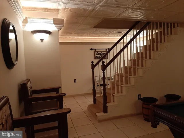 an aerial view of a house with a garden and lake view