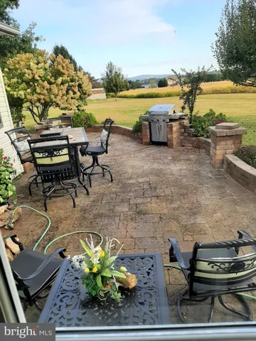 a terrace with wooden floor outdoor seating and lake view