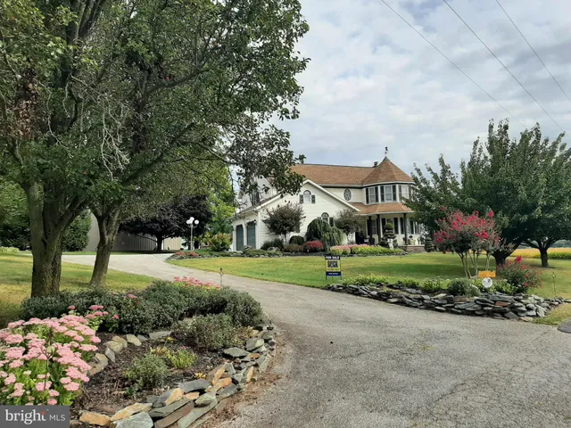 a front view of a house with a yard and pathway