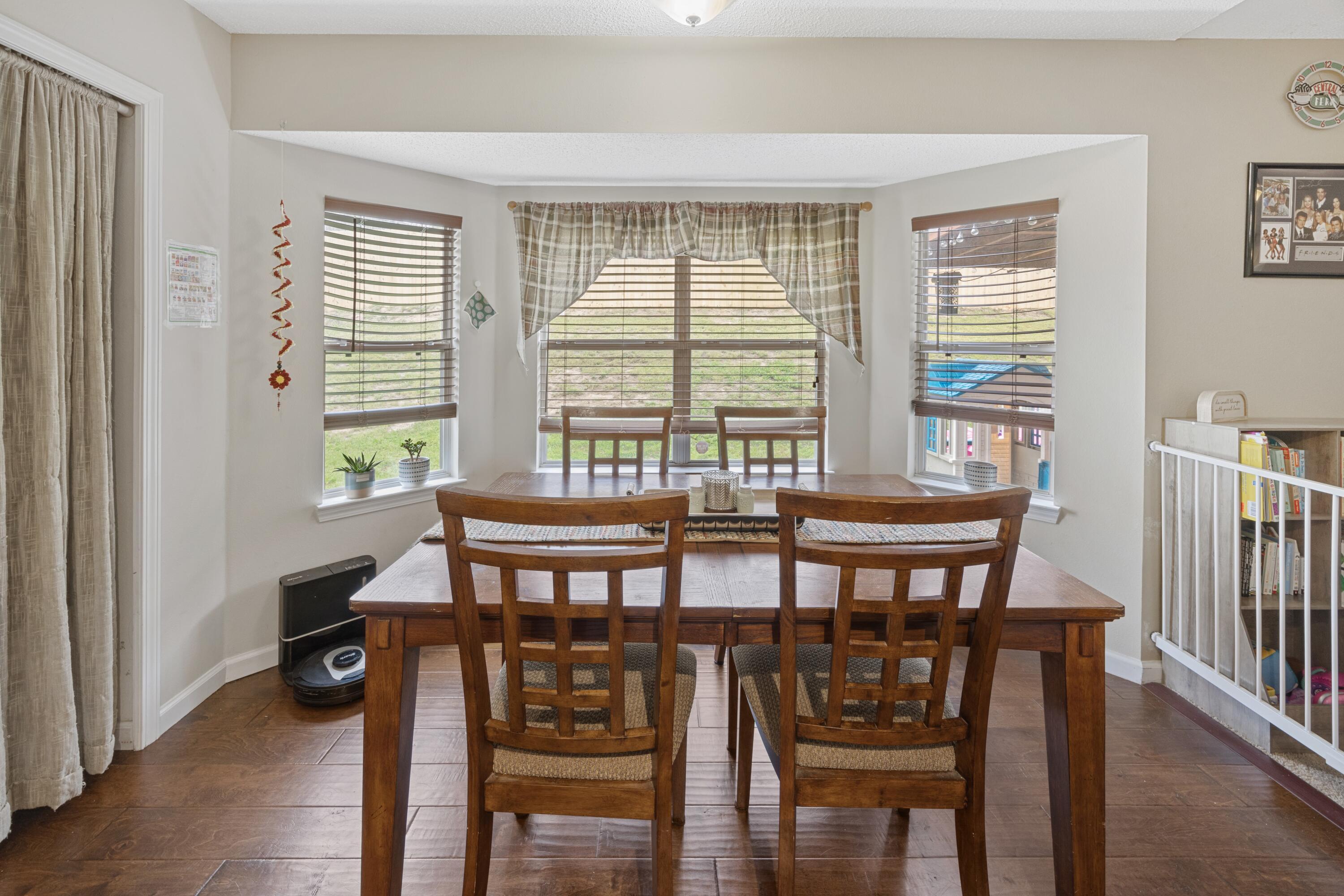 419 Bobby Drive Crestview, FL 32536 - Photo 14 of 42 a view of a dining room with furniture and wooden floor