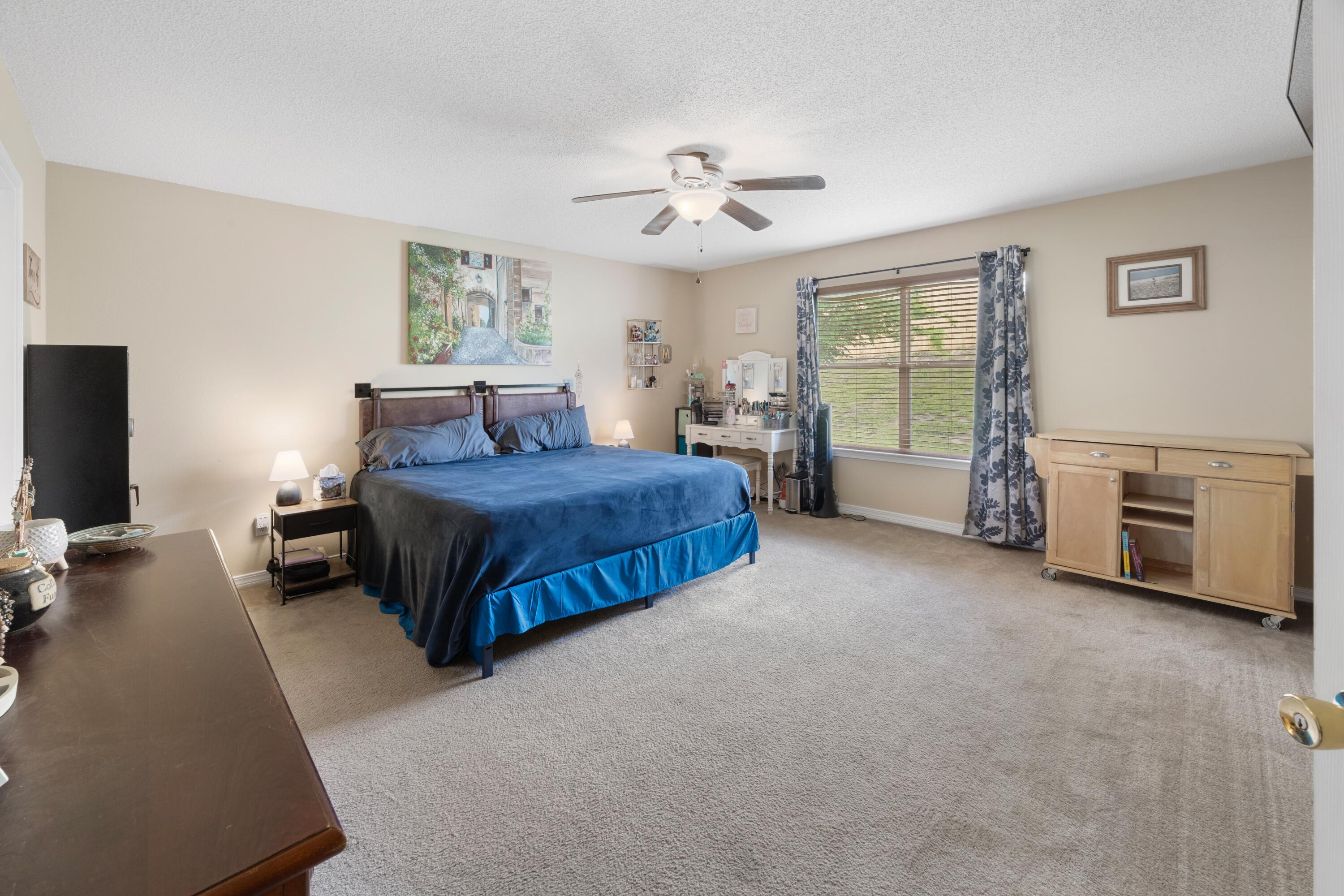 419 Bobby Drive Crestview, FL 32536 - Photo 16 of 42 a bedroom with a bed and a chandelier