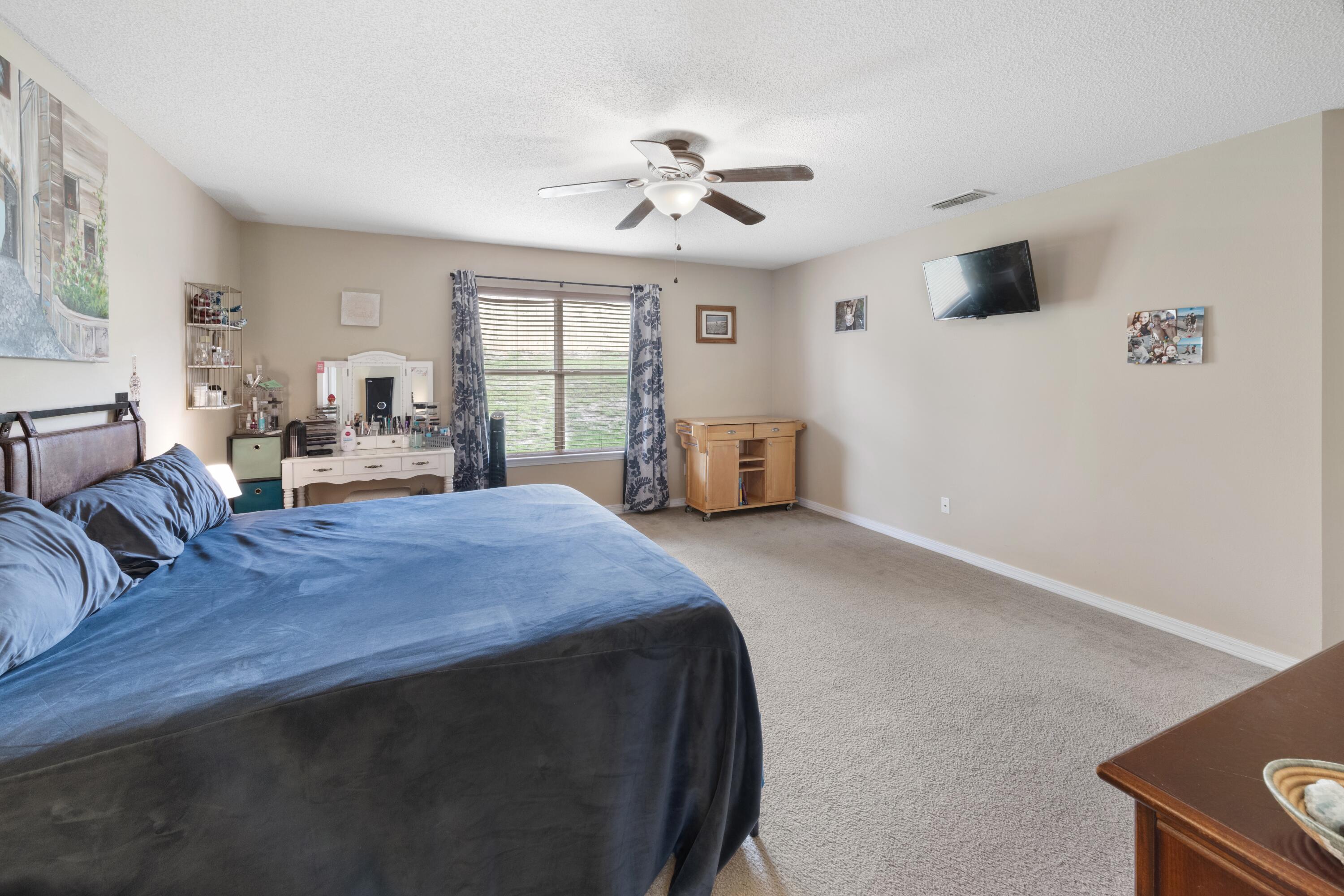 419 Bobby Drive Crestview, FL 32536 - Photo 18 of 42 a spacious bedroom with a bed and window