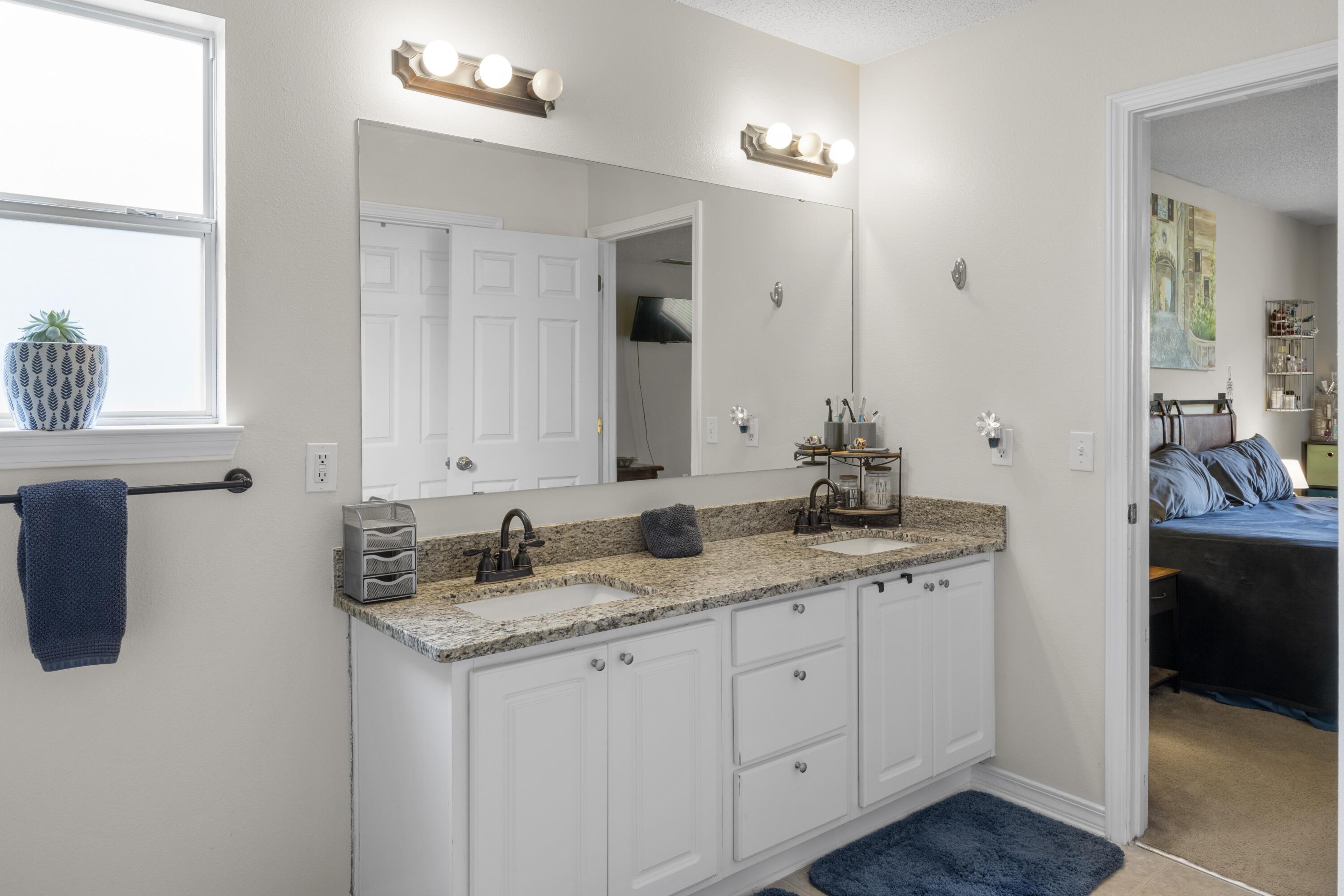 419 Bobby Drive Crestview, FL 32536 - Photo 21 of 42 a bathroom with a granite countertop sink and a mirror
