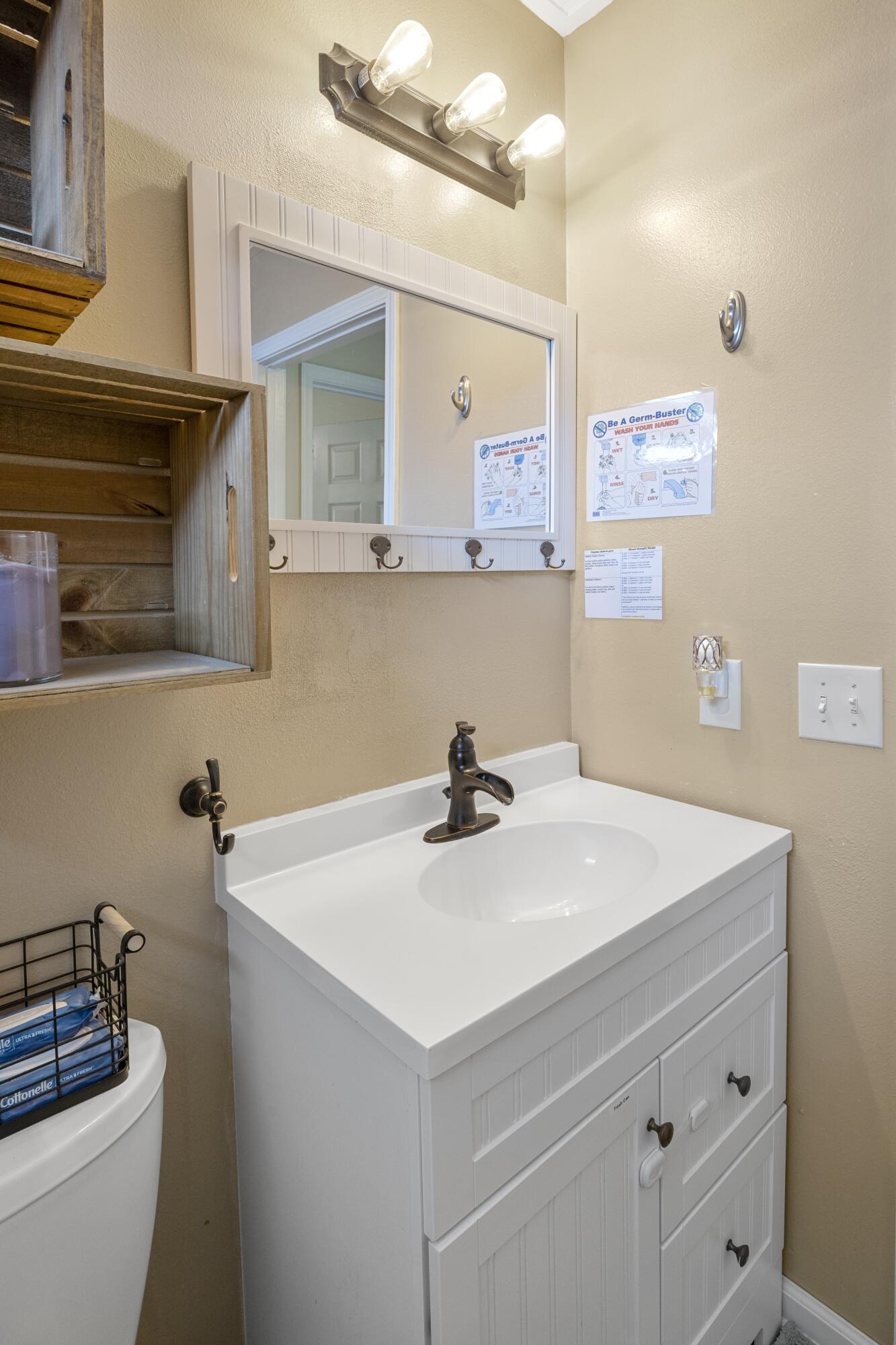 419 Bobby Drive Crestview, FL 32536 - Photo 30 of 42 a bathroom with a sink a vanity and a mirror