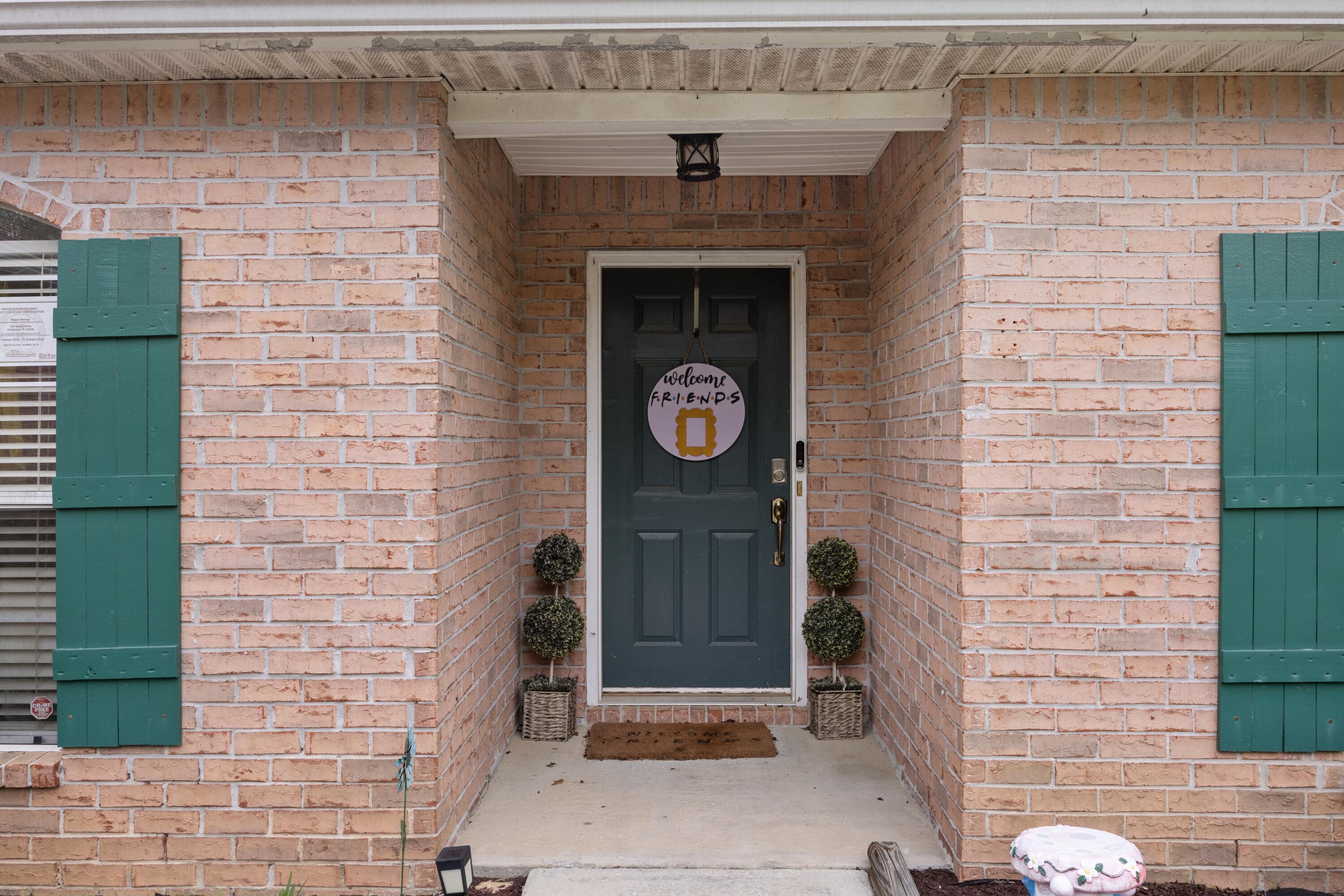 419 Bobby Drive Crestview, FL 32536 - Photo 3 of 42 a stone house with an outdoor space