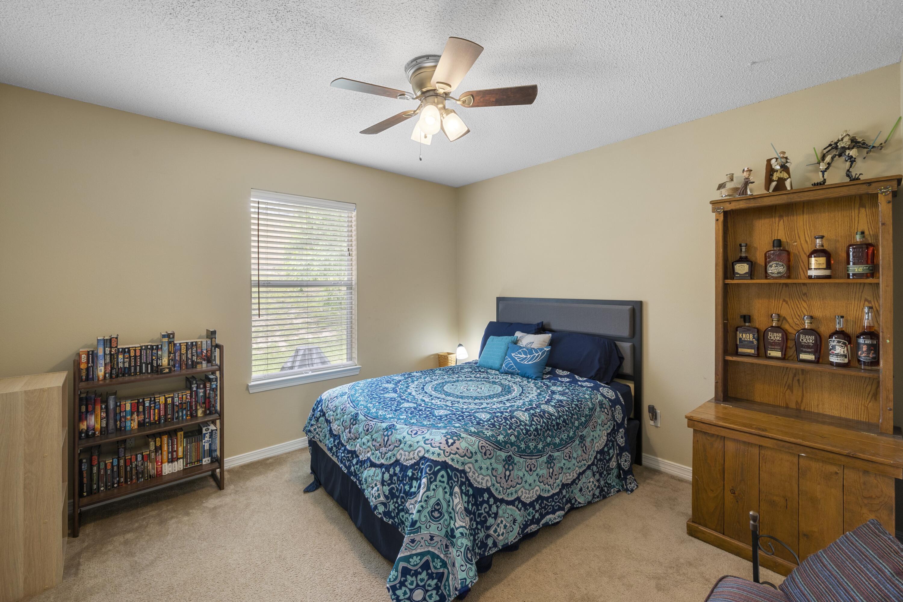 419 Bobby Drive Crestview, FL 32536 - Photo 31 of 42 a bedroom with a bed and a cabinets