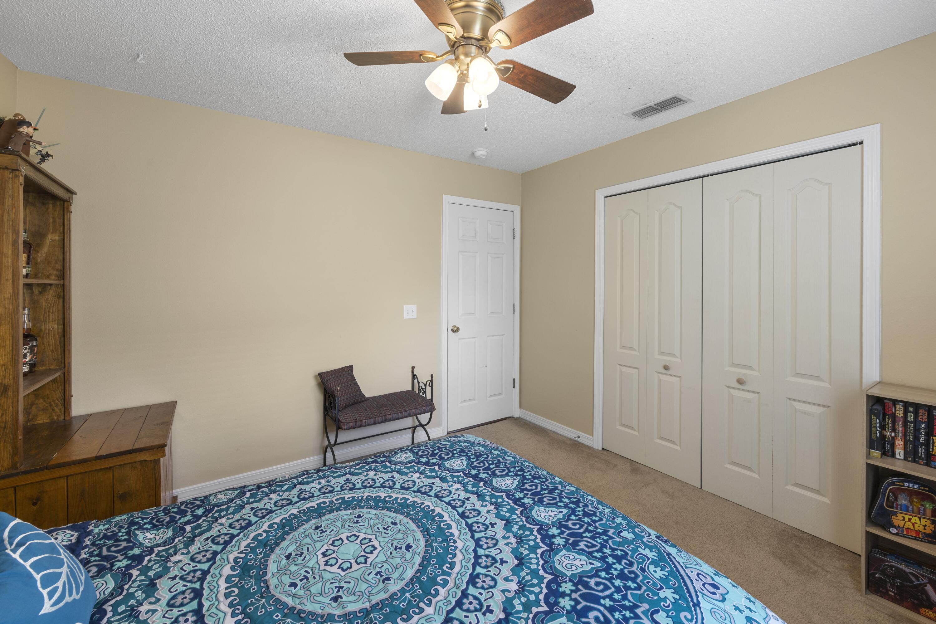 419 Bobby Drive Crestview, FL 32536 - Photo 32 of 42 a bedroom with a bed and a television