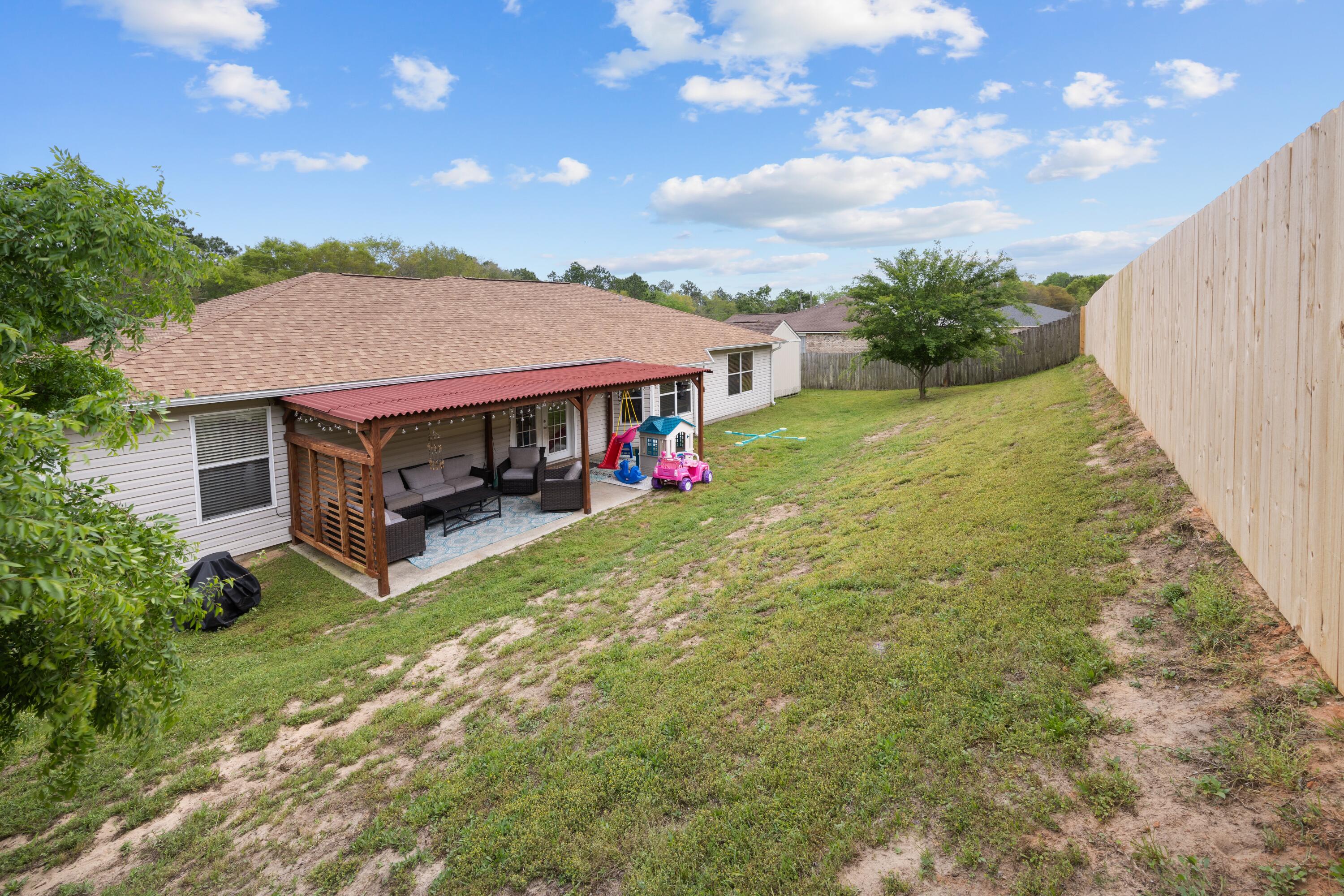 419 Bobby Drive Crestview, FL 32536 - Photo 35 of 42 a view of a house with swimming pool and sitting area
