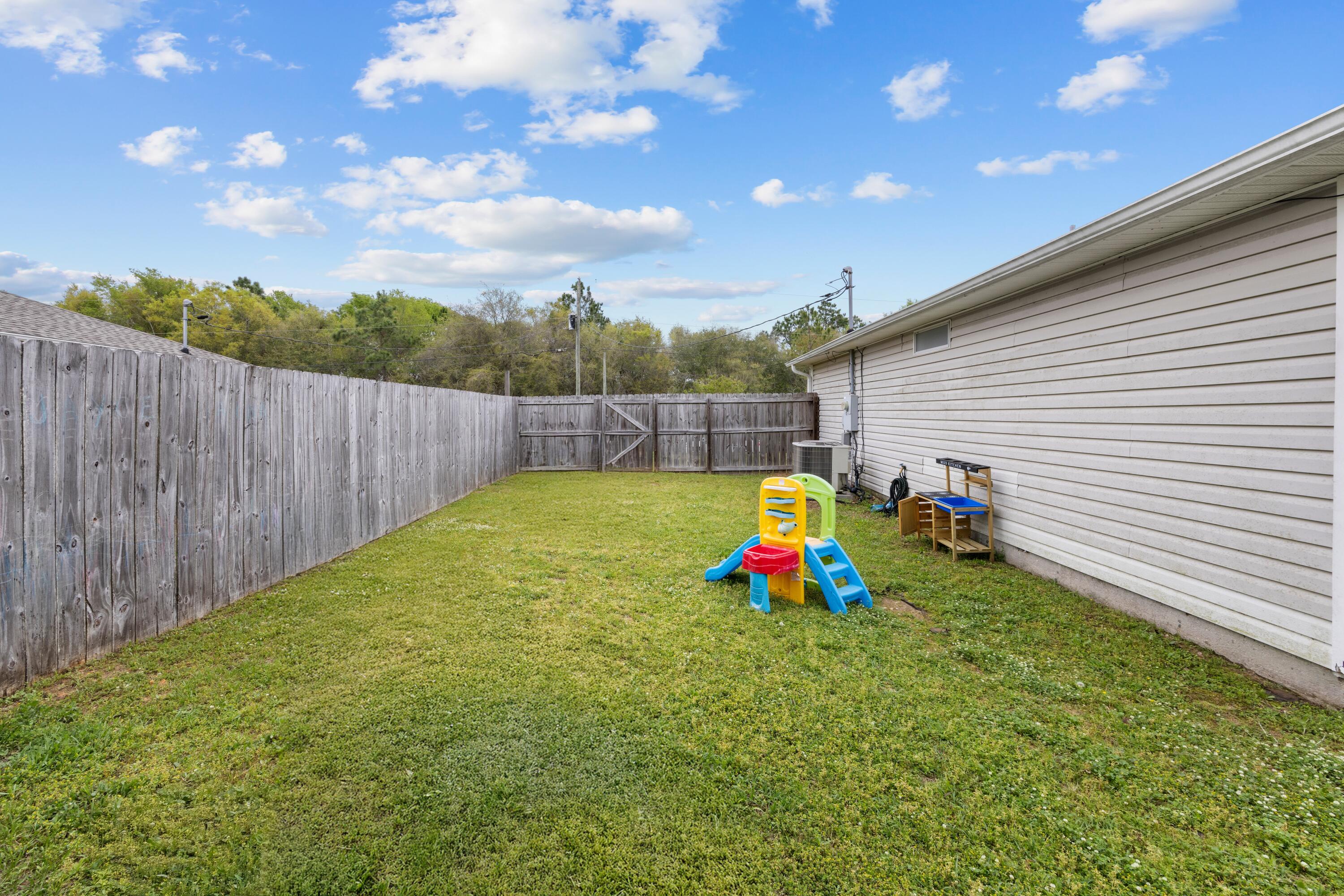 419 Bobby Drive Crestview, FL 32536 - Photo 37 of 42 a view of a backyard with a garden and entertaining space