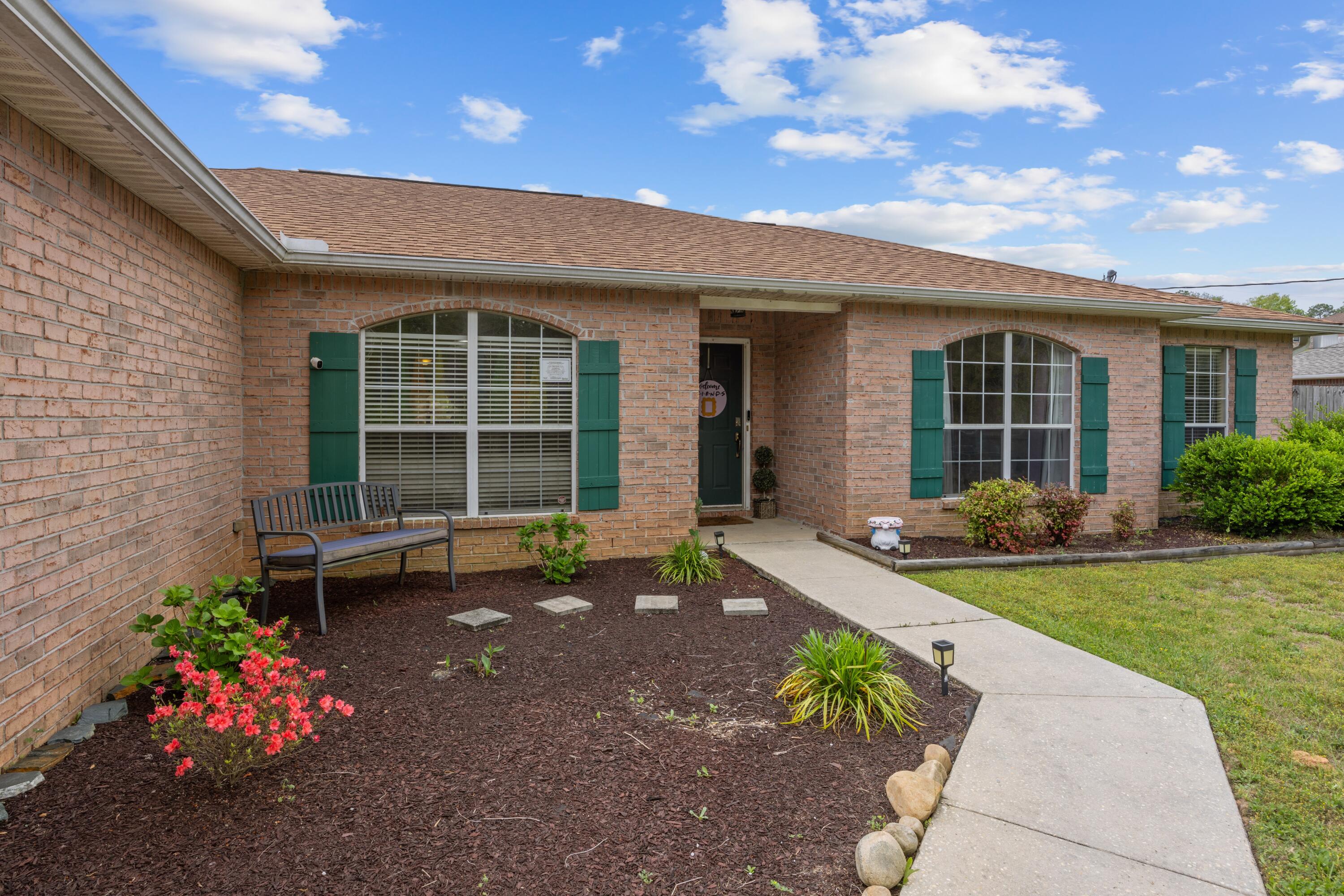 419 Bobby Drive Crestview, FL 32536 - Photo 4 of 42 a view of a house with backyard sitting area and garden