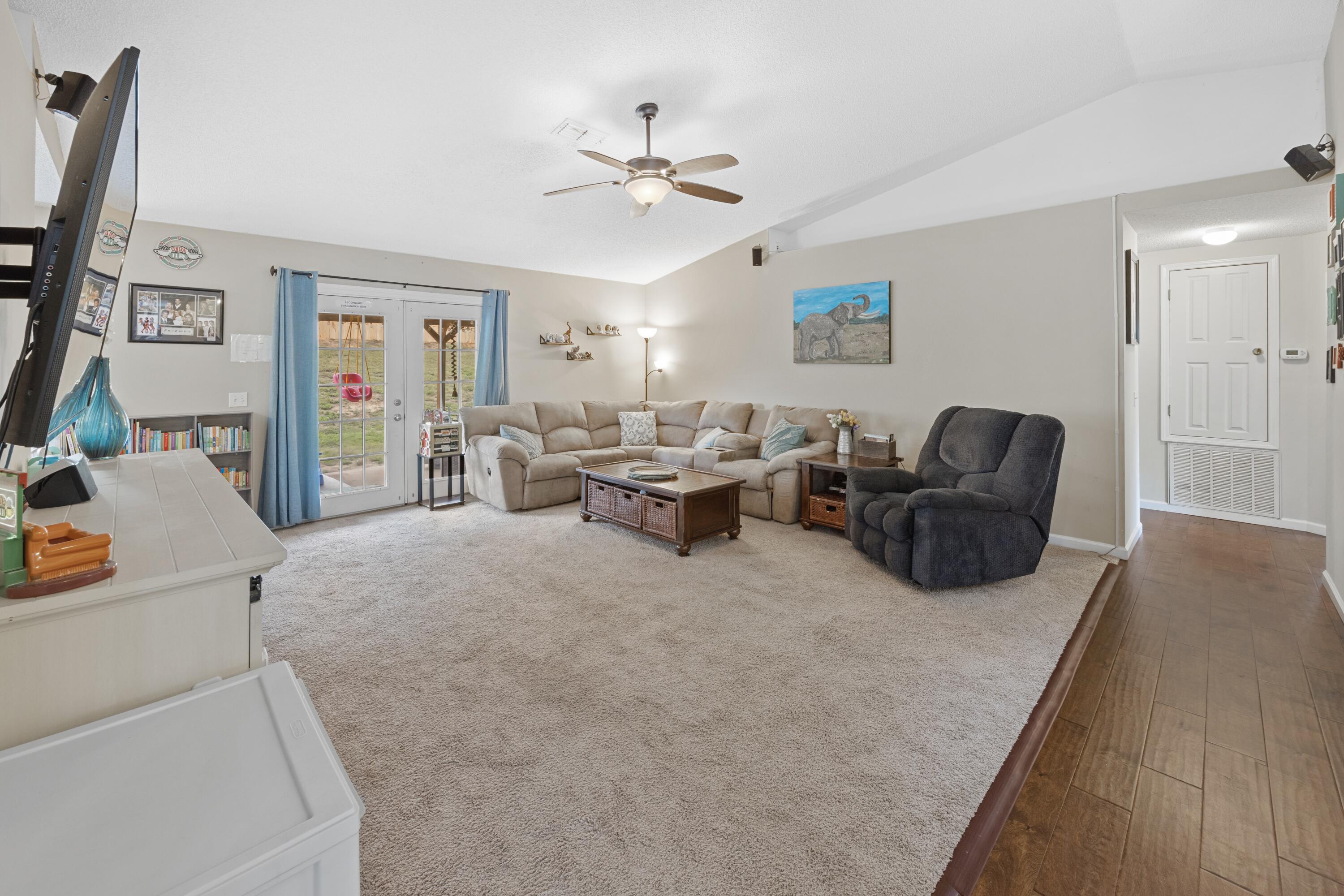 419 Bobby Drive Crestview, FL 32536 - Photo 7 of 42 a living room with furniture and a chandelier