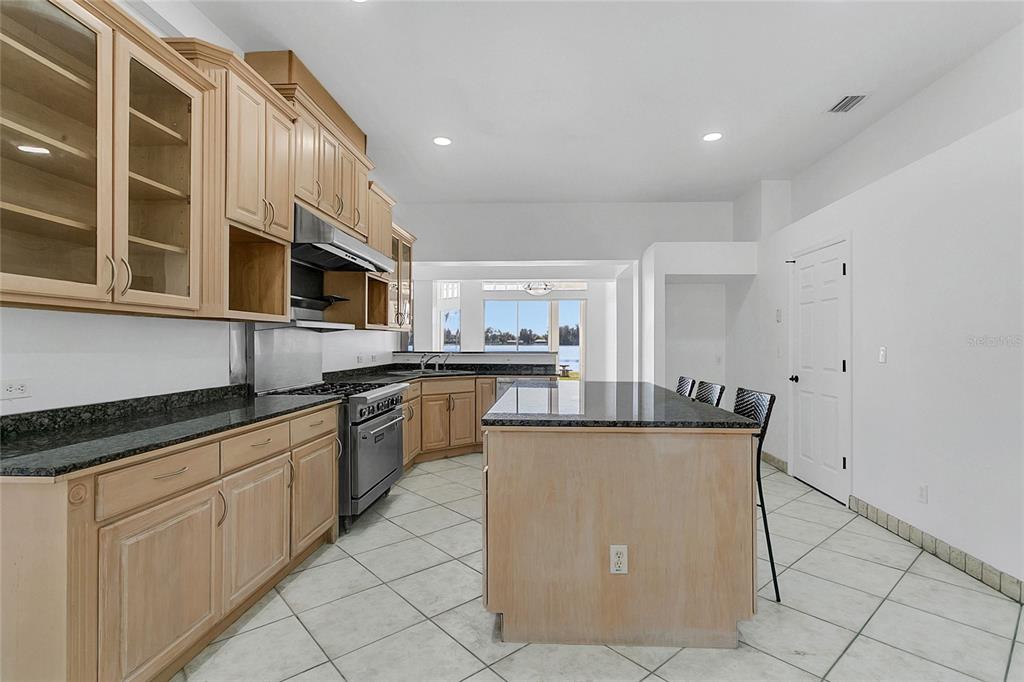 336 Mary Jess Road Orlando, FL 32839 - Photo 19 of 63 a kitchen with stainless steel appliances granite countertop a stove top oven a sink a counter space and cabinets