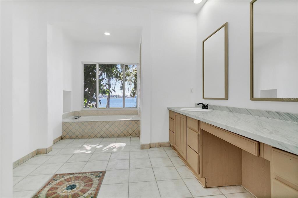 336 Mary Jess Road Orlando, FL 32839 - Photo 27 of 63 a spacious bathroom with a tub sink and mirror