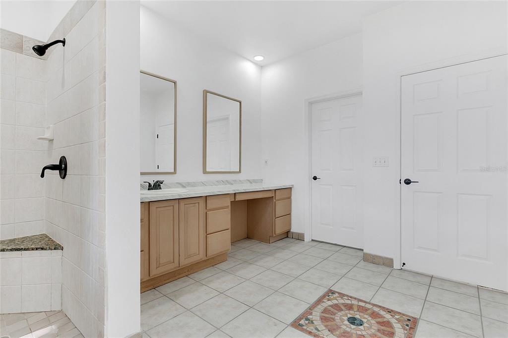 336 Mary Jess Road Orlando, FL 32839 - Photo 28 of 63 a bathroom with a sink a mirror and a shower