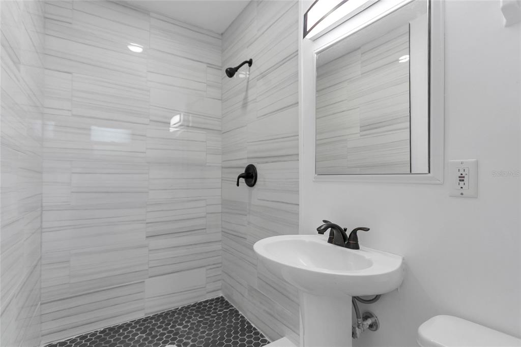 336 Mary Jess Road Orlando, FL 32839 - Photo 35 of 63 a bathroom with a sink a toilet and shower