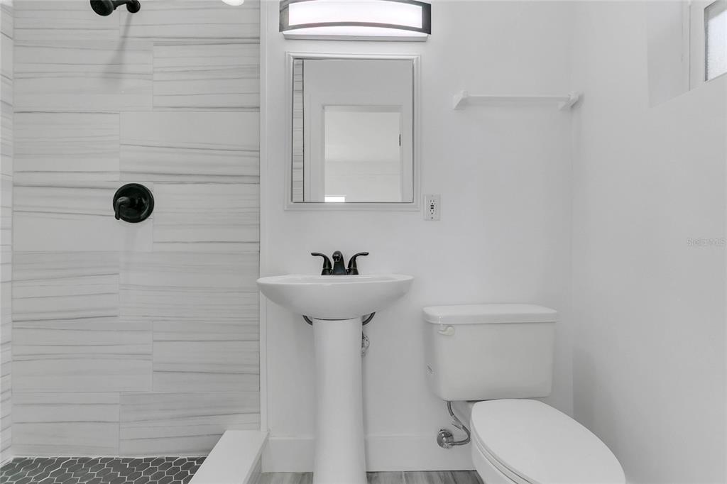 336 Mary Jess Road Orlando, FL 32839 - Photo 36 of 63 a bathroom with a toilet sink and mirror