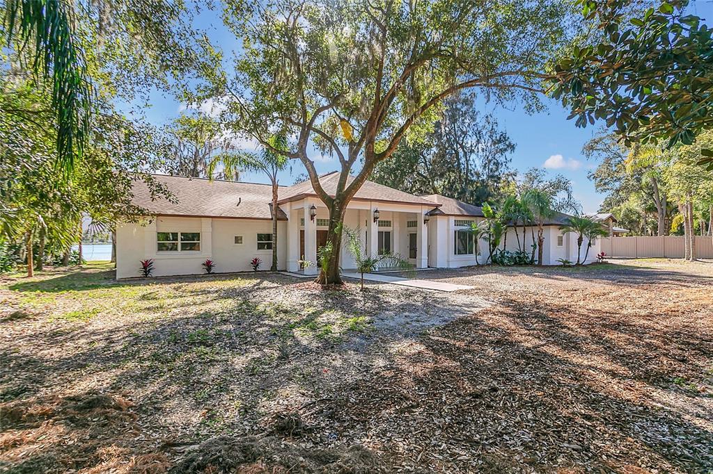 336 Mary Jess Road Orlando, FL 32839 - Photo 4 of 63 a front view of a house with a garden and trees