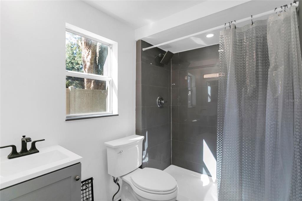 336 Mary Jess Road Orlando, FL 32839 - Photo 44 of 63 a bathroom with a toilet a sink and shower