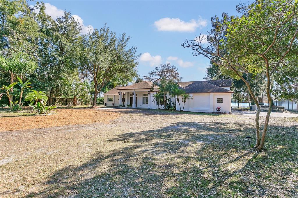 336 Mary Jess Road Orlando, FL 32839 - Photo 6 of 63 a front view of a house with a yard and trees