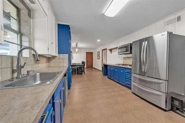 a kitchen with stainless steel appliances granite countertop a sink and cabinets