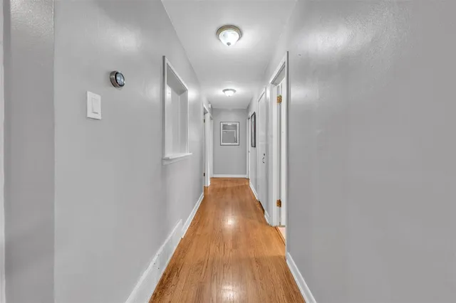 a view of a livingroom with wooden floor and a ceiling fan