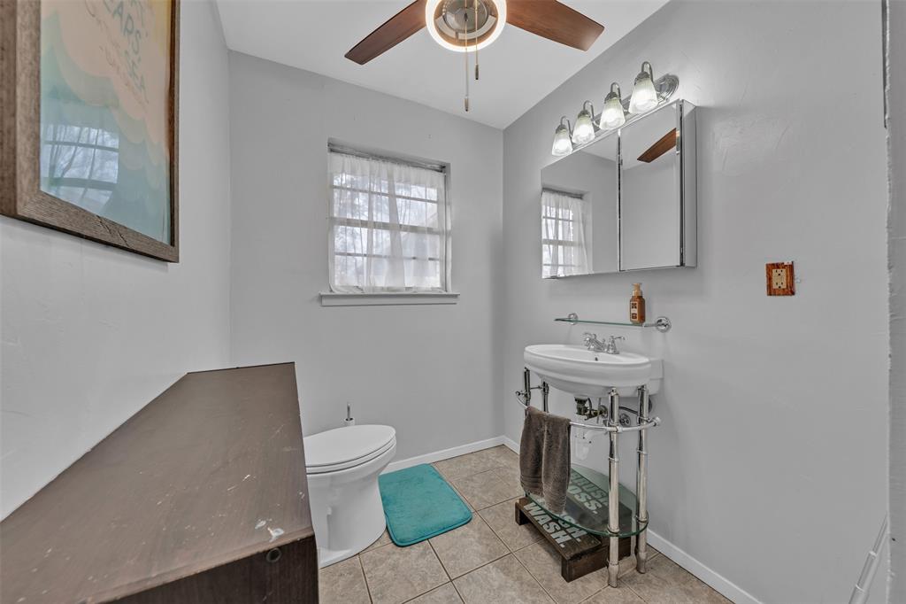 106 Lakeridge Road Lakeside, TX 76108 - Photo 20 of 40 a bathroom with a sink a toilet and mirror