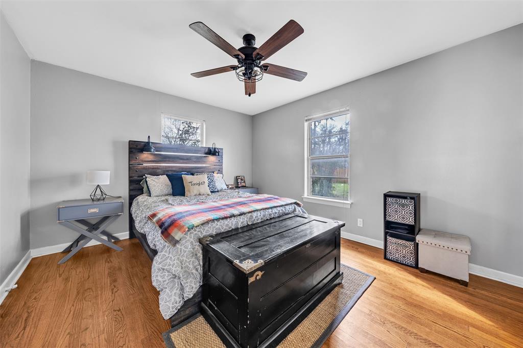 106 Lakeridge Road Lakeside, TX 76108 - Photo 23 of 40 a bedroom with a bed and wooden floor