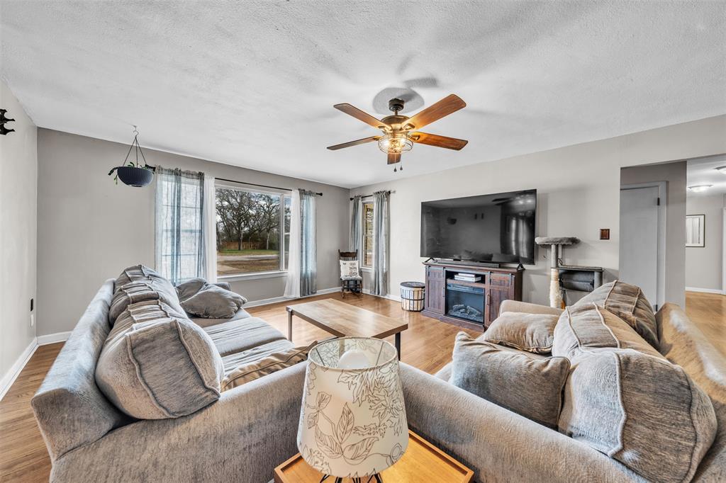 106 Lakeridge Road Lakeside, TX 76108 - Photo 10 of 40 a living room with furniture and a flat screen tv