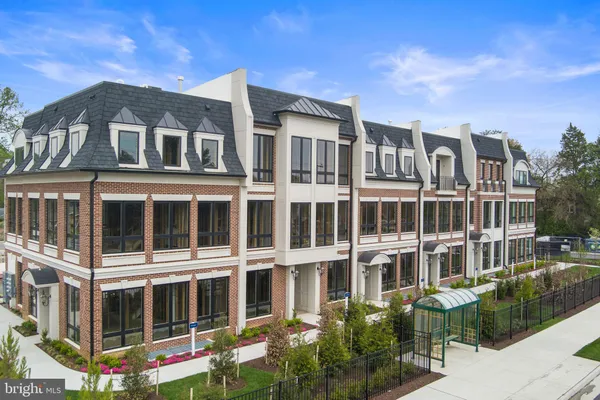 a front view of a residential apartment building with a yard