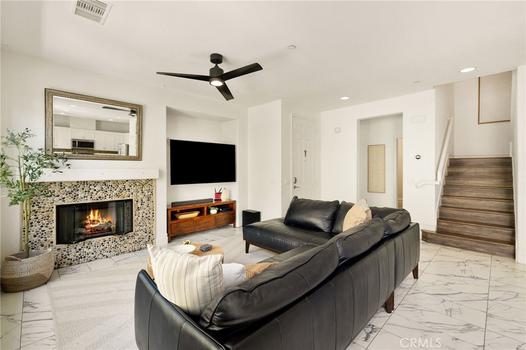 6807 Simmons Way Moorpark, CA 93021 - Photo 11 of 43 a living room with furniture fireplace and flat screen tv