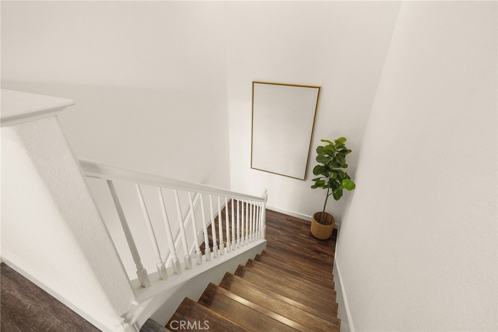 6807 Simmons Way Moorpark, CA 93021 - Photo 14 of 43 a view of a hallway with wooden floor and a potted plant