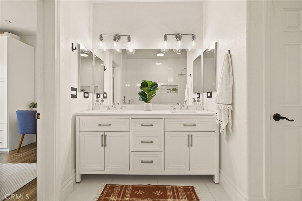 6807 Simmons Way Moorpark, CA 93021 - Photo 21 of 43 a bathroom with a double vanity sink and a mirror