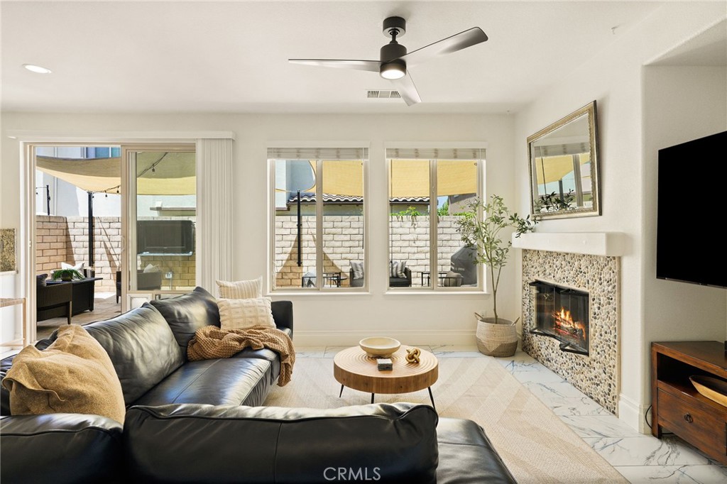 6807 Simmons Way Moorpark, CA 93021 - Photo 4 of 43 a living room with furniture a fireplace and a flat screen tv