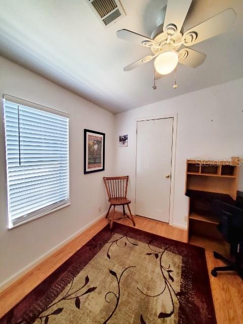 29200 South Jones Loop Road, Unit 125 Punta Gorda, FL 33950 - Photo 12 of 52 a bedroom with a bed and a chandelier