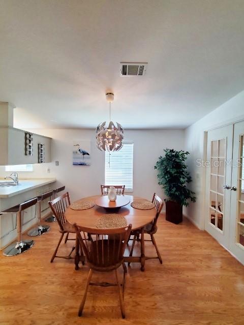 29200 South Jones Loop Road, Unit 125 Punta Gorda, FL 33950 - Photo 17 of 52 a view of a dining room with furniture and wooden floor