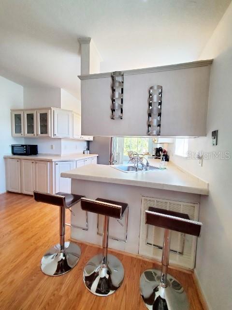 29200 South Jones Loop Road, Unit 125 Punta Gorda, FL 33950 - Photo 18 of 52 a kitchen with a sink and chairs