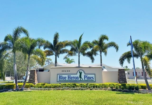 29200 South Jones Loop Road, Unit 125 Punta Gorda, FL 33950 - Photo 2 of 52 a sign board with palm trees