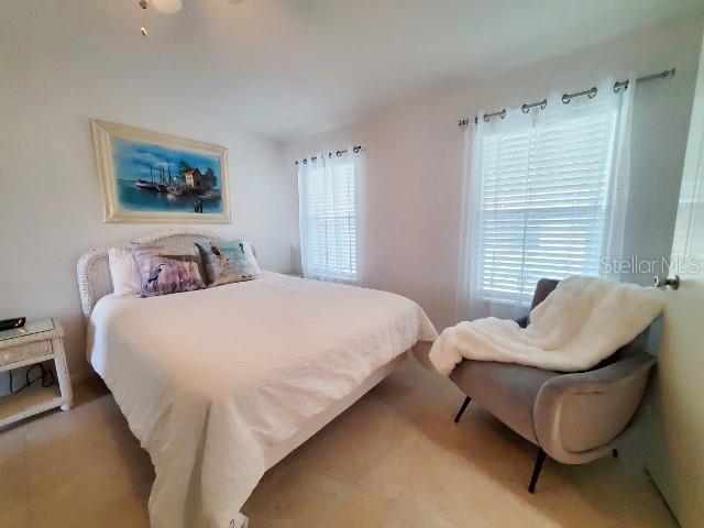 29200 South Jones Loop Road, Unit 125 Punta Gorda, FL 33950 - Photo 21 of 52 a bedroom with bed and a couch