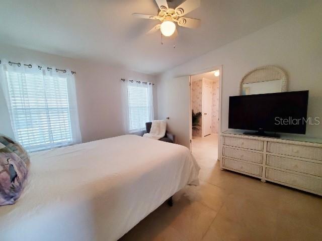 29200 South Jones Loop Road, Unit 125 Punta Gorda, FL 33950 - Photo 23 of 52 a bedroom with a large bed and a flat screen tv