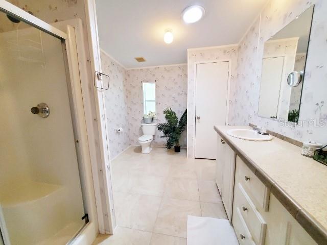 29200 South Jones Loop Road, Unit 125 Punta Gorda, FL 33950 - Photo 24 of 52 a spacious bathroom with a double vanity sink a mirror and a shower