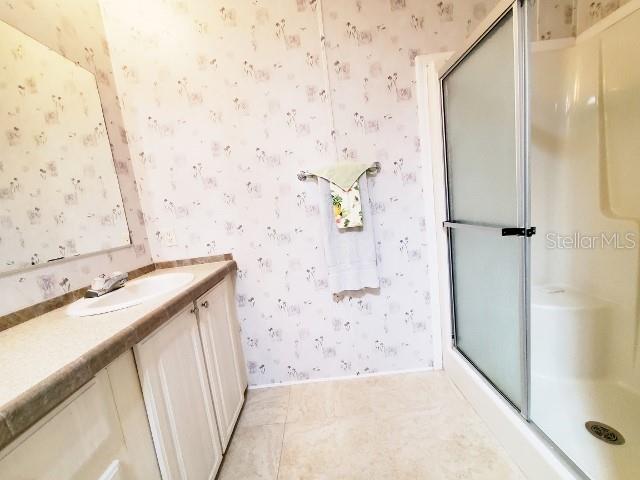 29200 South Jones Loop Road, Unit 125 Punta Gorda, FL 33950 - Photo 27 of 52 a bathroom with a sink and a mirror