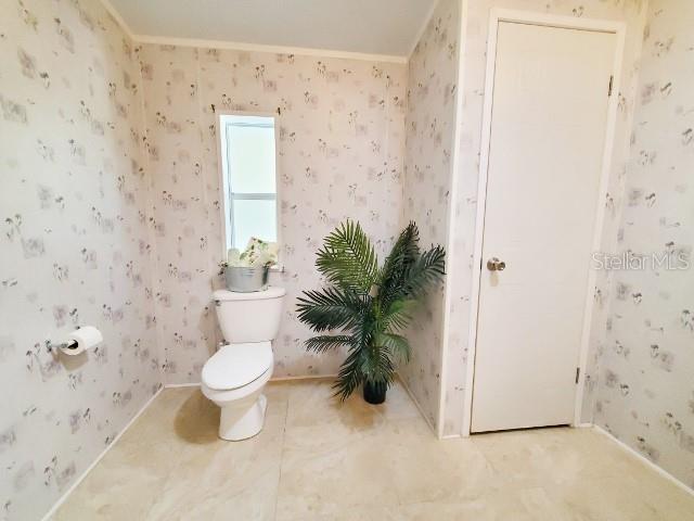 29200 South Jones Loop Road, Unit 125 Punta Gorda, FL 33950 - Photo 30 of 52 a white toilet sitting next to a bathroom sink