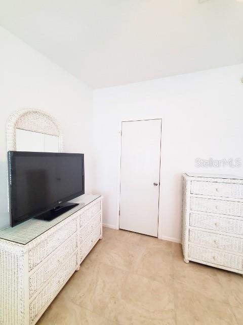 29200 South Jones Loop Road, Unit 125 Punta Gorda, FL 33950 - Photo 32 of 52 a living room with a flat screen tv and dresser