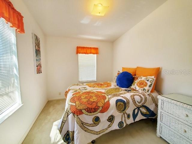 29200 South Jones Loop Road, Unit 125 Punta Gorda, FL 33950 - Photo 34 of 52 a bedroom with a bed and window