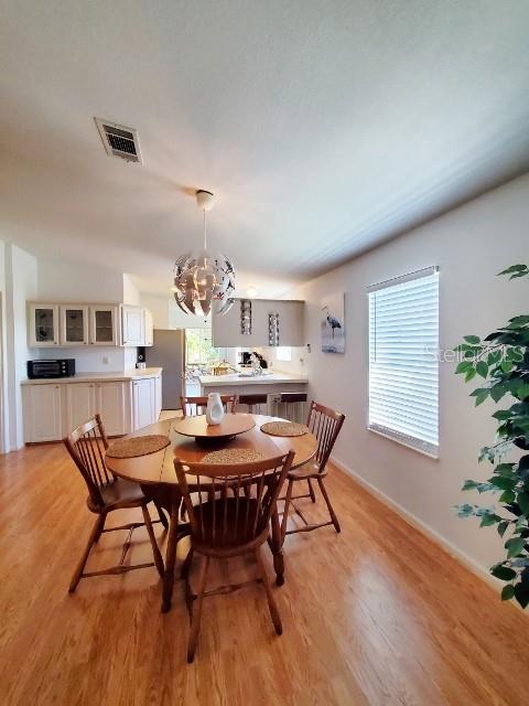 29200 South Jones Loop Road, Unit 125 Punta Gorda, FL 33950 - Photo 36 of 52 a dining room with furniture and wooden floor