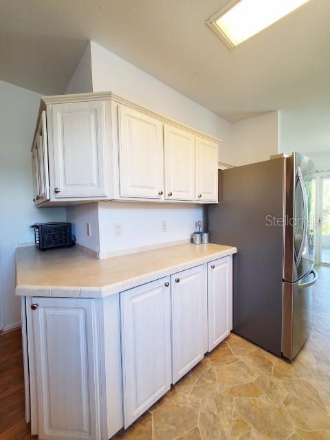 29200 South Jones Loop Road, Unit 125 Punta Gorda, FL 33950 - Photo 40 of 52 a kitchen with stainless steel appliances granite countertop a granite counter tops and a refrigerator