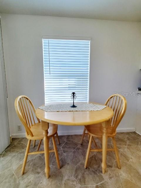 29200 South Jones Loop Road, Unit 125 Punta Gorda, FL 33950 - Photo 44 of 52 a view of a dining room with furniture and window