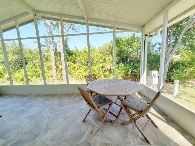 29200 South Jones Loop Road, Unit 125 Punta Gorda, FL 33950 - Photo 48 of 52 a view of a patio with table and chairs