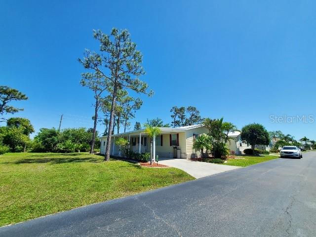 29200 South Jones Loop Road, Unit 125 Punta Gorda, FL 33950 - Photo 51 of 52 a front view of a house with garden
