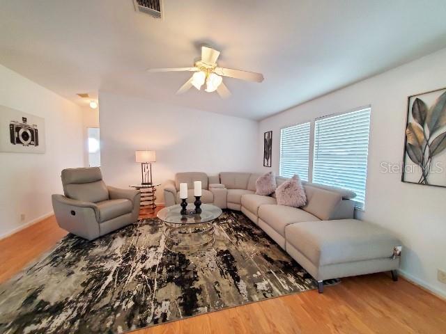 29200 South Jones Loop Road, Unit 125 Punta Gorda, FL 33950 - Photo 6 of 52 a living room with furniture and a wooden floor